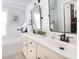 Bathroom with double sink vanity, black hardware, and shiplap accent wall at 700 Preservation Pl, Mount Pleasant, SC 29464