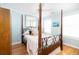 Cozy bedroom with four poster bed frame, hardwood floors, and ample natural light at 700 Preservation Pl, Mount Pleasant, SC 29464