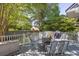Inviting deck with outdoor seating and a grill, surrounded by lush greenery at 700 Preservation Pl, Mount Pleasant, SC 29464
