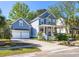 Charming two-story home with a manicured lawn, a two-car garage, and a welcoming front porch at 700 Preservation Pl, Mount Pleasant, SC 29464