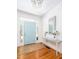 Bright foyer features hardwood floors, a stylish light fixture, and a decorative table with fresh flowers at 700 Preservation Pl, Mount Pleasant, SC 29464