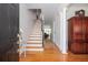 Inviting foyer with hardwood floors, a staircase, and an elegant wood armoire at 700 Preservation Pl, Mount Pleasant, SC 29464