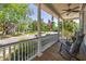 Charming front porch with rocking chairs, an American flag, and views of the neighborhood at 700 Preservation Pl, Mount Pleasant, SC 29464