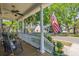 Inviting front porch with rocking chairs, an American flag, and ceiling fan at 700 Preservation Pl, Mount Pleasant, SC 29464