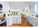 Bright and airy kitchen with a breakfast bar that opens up to the living and dining areas at 700 Preservation Pl, Mount Pleasant, SC 29464