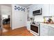Stylish kitchen with light blue cabinets, stainless steel appliances, and hardwood floors at 700 Preservation Pl, Mount Pleasant, SC 29464