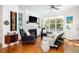 Bright living room with hardwood floors, a cozy fireplace, and plenty of natural light from large windows at 700 Preservation Pl, Mount Pleasant, SC 29464