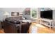 Cozy living room featuring hardwood floors, comfortable seating, and natural light from the bright window at 700 Preservation Pl, Mount Pleasant, SC 29464