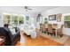 Open-concept living room and dining area with hardwood floors and plenty of natural light at 700 Preservation Pl, Mount Pleasant, SC 29464