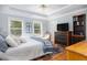 Bright main bedroom boasts two windows, hardwood floors, and ceiling fan at 700 Preservation Pl, Mount Pleasant, SC 29464