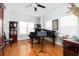 Elegant music room with a grand piano, hardwood floors, and plenty of natural light at 700 Preservation Pl, Mount Pleasant, SC 29464