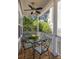 Inviting outdoor dining area on the covered porch with a glass table and comfortable seating at 700 Preservation Pl, Mount Pleasant, SC 29464