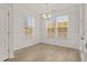 Dining area with large windows offering ample natural light, hardwood floors and modern lighting at 753 Maynard Ln, Summerville, SC 29486