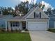Charming single-story home with a well-manicured lawn, attached garage, and inviting entryway at 753 Maynard Ln, Summerville, SC 29486