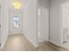Bright entryway featuring hardwood floors, white trim, and a view of the front door and bathroom at 753 Maynard Ln, Summerville, SC 29486