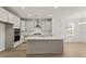 Modern kitchen featuring white cabinets, stainless steel appliances, an island, and a view to dining area at 753 Maynard Ln, Summerville, SC 29486