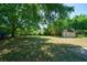 Expansive green backyard with mature trees and a small shed provides space for outdoor activities at 779 Dills Bluff Rd, Charleston, SC 29412