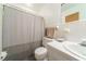 Standard white tiled bathroom offers a sink, toilet, bath and shower combo with modern shower curtain at 779 Dills Bluff Rd, Charleston, SC 29412