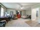 Spacious carpeted bedroom with ceiling fan, multiple windows, a bed, office space and doorway at 779 Dills Bluff Rd, Charleston, SC 29412