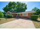 Charming single-story brick home featuring a spacious driveway and mature landscaping at 779 Dills Bluff Rd, Charleston, SC 29412