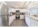 Updated kitchen with white cabinets, stainless appliances, granite counters, and modern flooring at 779 Dills Bluff Rd, Charleston, SC 29412