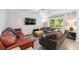 Cozy living room with comfortable seating, a ceiling fan, and sliding glass doors to the backyard at 779 Dills Bluff Rd, Charleston, SC 29412