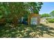 Backyard shed has plenty of room for storage or hobbies, surrounded by lush greenery and trees at 779 Dills Bluff Rd, Charleston, SC 29412