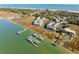 Aerial view showcases the coastal homes, waterways, and marshland landscape at 81 Sandbar Ln # 19, Folly Beach, SC 29439