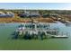 Aerial view of a waterfront community featuring boat lifts and docks on the marsh at 81 Sandbar Ln # 19, Folly Beach, SC 29439