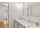 Bright bathroom with double sink, shell decorations, and a view to another room at 81 Sandbar Ln # 19, Folly Beach, SC 29439
