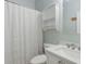 Bright bathroom showcasing a white cabinet, sink, toilet, and a shower with a white curtain at 81 Sandbar Ln # 19, Folly Beach, SC 29439