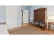 Bedroom features wooden floors, large armoire, and an open door to another room at 81 Sandbar Ln # 19, Folly Beach, SC 29439