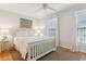 Cozy bedroom with natural light, featuring a queen-sized bed and hardwood floors at 81 Sandbar Ln # 19, Folly Beach, SC 29439