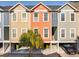 Charming townhouse exterior with colorful siding, covered parking, and a tropical palm tree at 81 Sandbar Ln # 19, Folly Beach, SC 29439