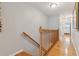 Hallway featuring hardwood floors, wooden banister, and access to rooms at 81 Sandbar Ln # 19, Folly Beach, SC 29439