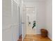 Hallway with closet and door to bathroom with tiled floor, toilet, and plants at 81 Sandbar Ln # 19, Folly Beach, SC 29439