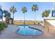 Community pool area with palm trees, lounge chairs, and waterfront views at 81 Sandbar Ln # 19, Folly Beach, SC 29439
