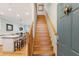 View of a wooden staircase leading upstairs from the kitchen area at 81 Sandbar Ln # 19, Folly Beach, SC 29439