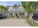 Charming townhome exterior featuring a well-maintained yard, covered porch, and convenient parking at 9105 Parlor Dr, Ladson, SC 29456