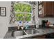 Kitchen sink features granite counters, modern faucet, and scenic window view at 9105 Parlor Dr, Ladson, SC 29456