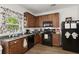 Traditional kitchen with brown cabinets, black appliances, and granite countertops at 9105 Parlor Dr, Ladson, SC 29456