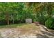 Spacious backyard with mature trees, privacy fence, and storage shed at 10 Skyeman Dr, Charleston, SC 29414