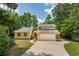 Inviting home exterior with a two-car garage and large driveway at 10 Skyeman Dr, Charleston, SC 29414