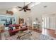 Cozy living room features a red leather couch, area rug, and high ceilings with a fan at 10 Skyeman Dr, Charleston, SC 29414