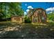 Back exterior of a brick home with a spacious yard and mature trees for privacy at 100 Colonial Dr, Goose Creek, SC 29445