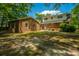 Expansive backyard featuring a brick home, separate brick structure, and ample space for outdoor enjoyment at 100 Colonial Dr, Goose Creek, SC 29445