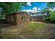 Spacious backyard featuring a two-story brick home and separate brick structure surrounded by mature trees at 100 Colonial Dr, Goose Creek, SC 29445