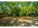 Lush backyard with mature trees and bamboo offering shade and privacy to this property at 100 Colonial Dr, Goose Creek, SC 29445