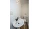 Simple bathroom featuring a pedestal sink and toilet, with clean white walls and modern fixtures at 100 Colonial Dr, Goose Creek, SC 29445