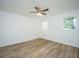 Cozy bedroom featuring hardwood floors, a ceiling fan, and natural light from the windows at 100 Colonial Dr, Goose Creek, SC 29445